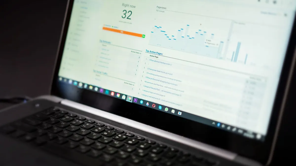 Laptop screen showing a website analytics dashboard with a performance score and traffic charts