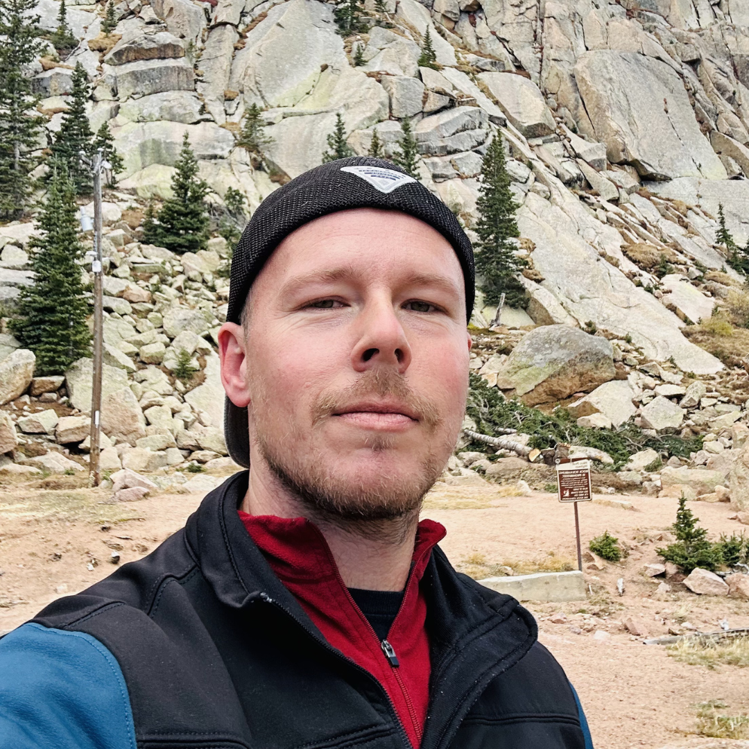 Portrait of Zach Heern, founder of Platypus Media, photographed in front of a Colorado mountain ridge.